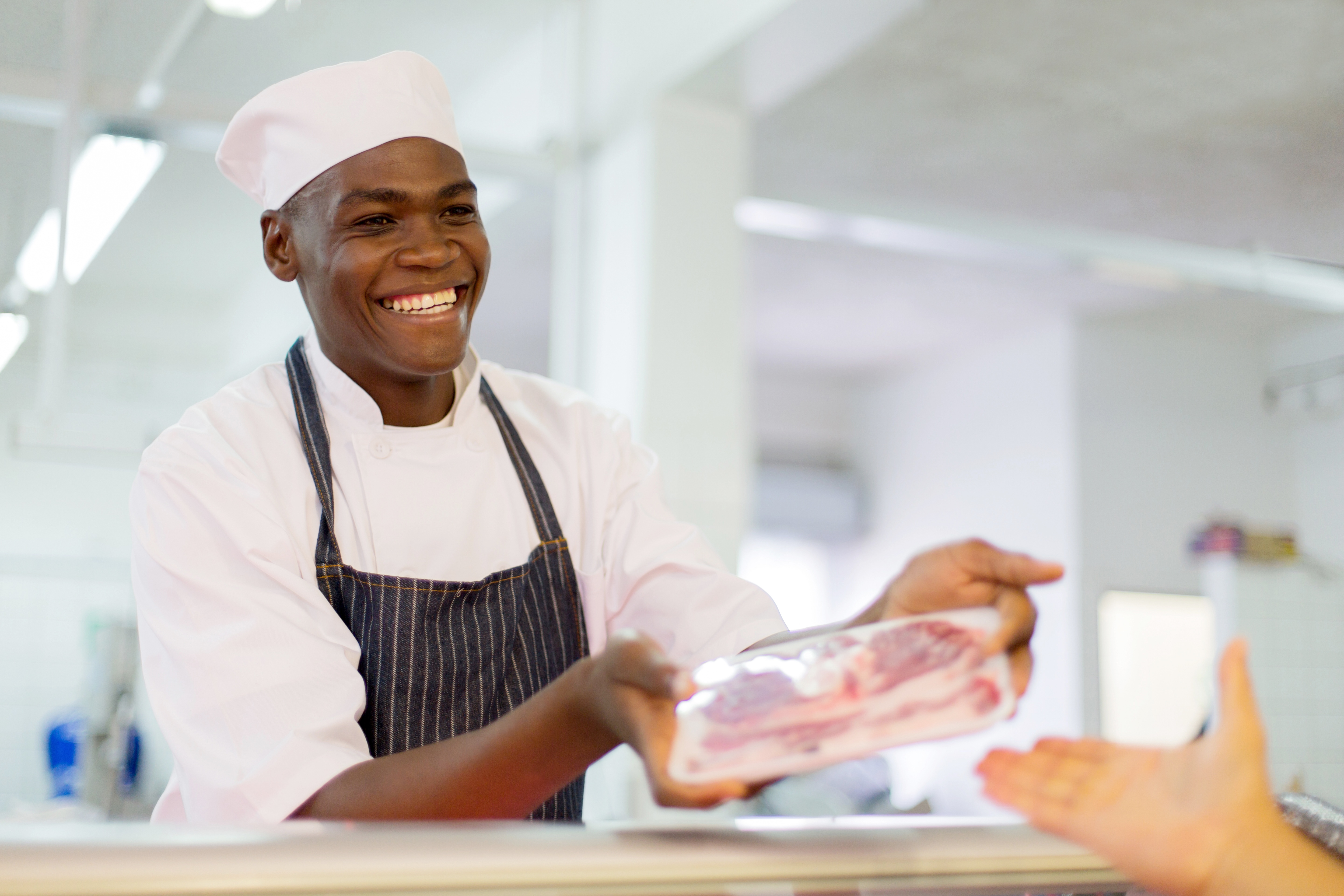 african-butcher-selling-beef-to-customer-515916472_5760x3840